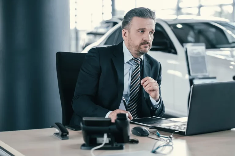 Car salesperson planning their daily routine at dealership desk