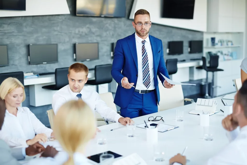 Dealership manager leading a team meeting to improve gross profit